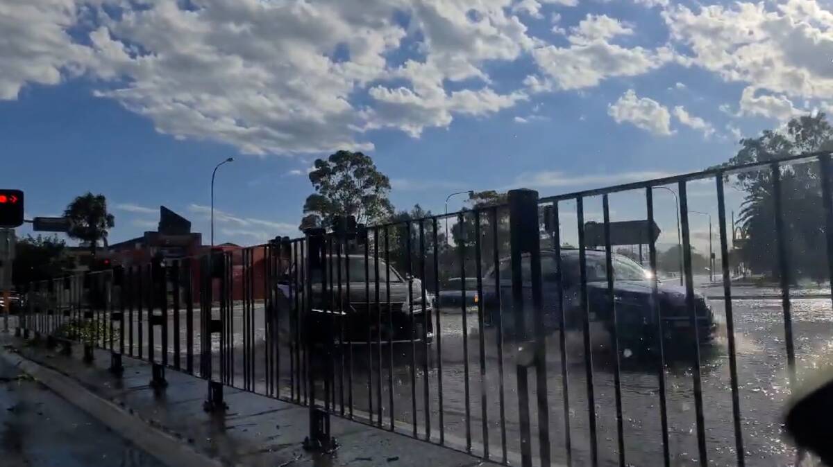 Cars drive through a flooded Shellharbour Road after the area was inundated with 31mm of rain between 5pm to 6:30pm on Saturday, January 15.