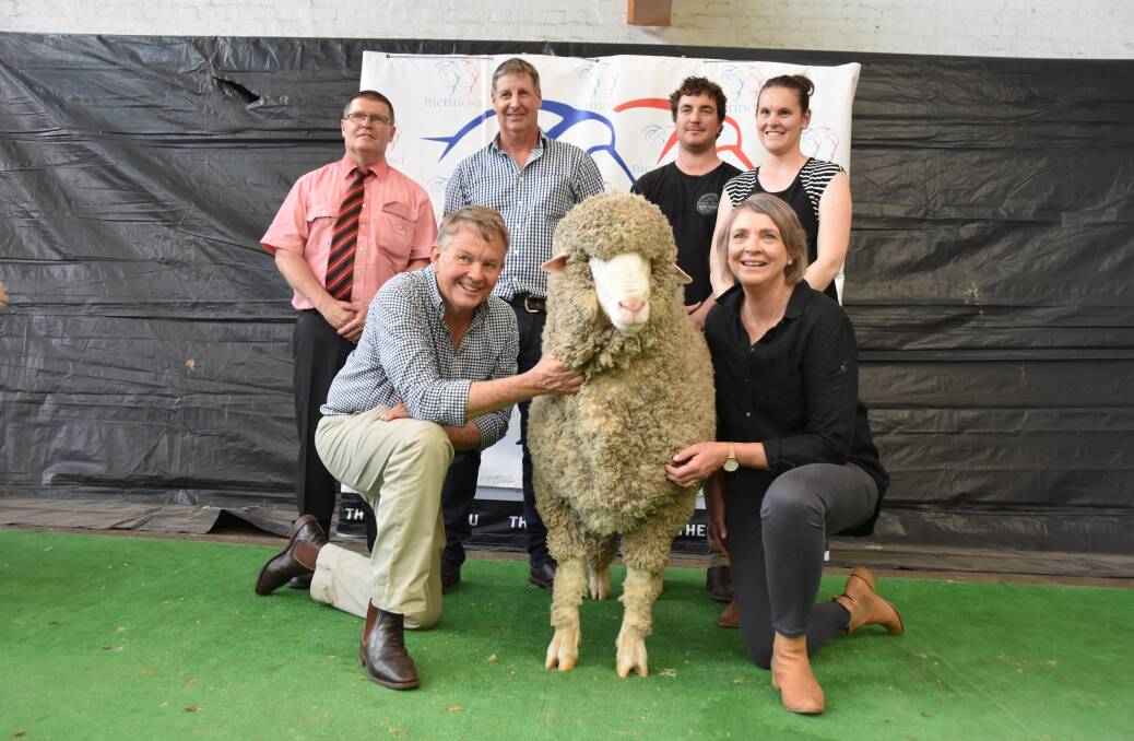STAR LOT: (back) Elders' Tony Wetherall, Paul Cousins and buyers Jesse and Courtney Hull, with Geoff and Bernadette Davidson holding their $70,000 'Lightning' ram. STAR LOT: (back) Elders' Tony Wetherall, Paul Cousins and buyers Jesse and Courtney Hull, with Geoff and Bernadette Davidson holding their $70,000 'Lightning' ram.