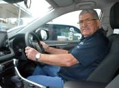 LET'S RIDE: John Santos behind the wheel of the car provided by the Cancer Council to help transport patients to their appointments.
