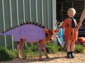 Samuel Schutz and his Jersey calf as Dino and Fred Flintstone.