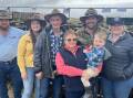 FAMILY: Louis and Sharon Pendergast, Benambra, with their family including James and Jessica Neven and son Charles, 2, and Stuart and Ashleigh Pendergast, sold a draft of Black Baldy steers to a top price of $2180.