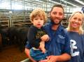 TOP PEN: Matt Howard with son Raffy, 2, and sister Sarah Howard, sold 31 heifers, including 10 Angus heifers, 395kg, for $1090 or 275c/kg.