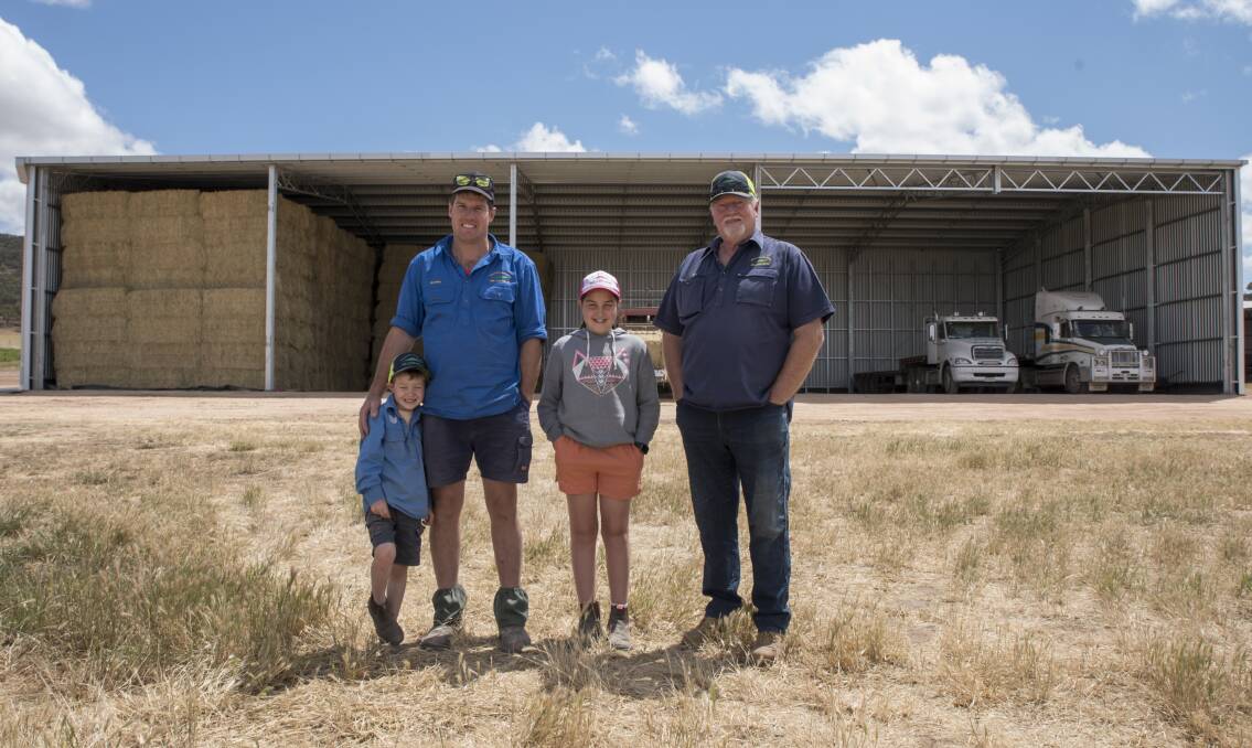 Grant Ross, his son Bradley and grandchildren. The shed features a girder truss for easy access of large machinery 