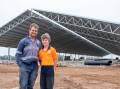 Managing risk: Dairy farmer Jade Clymo with his son Fynn and their new Entegra barn. Picture: Supplied