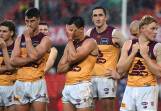 Brisbane players couldn't hide their disappointment after their thumping loss to the Suns. Photo: Dave Hunt/AAP PHOTOS