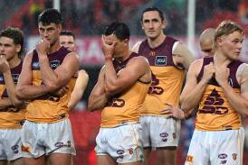 Brisbane players couldn't hide their disappointment after their thumping loss to the Suns. Photo: Dave Hunt/AAP PHOTOS
