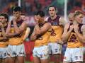 Brisbane players couldn't hide their disappointment after their thumping loss to the Suns. Photo: Dave Hunt/AAP PHOTOS