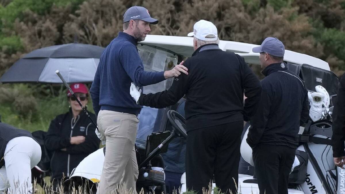 Donald Trump was playing golf with his son Eric and the US ambassador to Britain and his son. (AP PHOTO) Donald Trump was playing golf with his son Eric and the US ambassador to Britain and his son. (AP PHOTO)