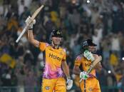 Peshawar Zalmi's Aaron Hardie lifts his bat aloft after their Pakistan Super League title triumph. Photo: AP PHOTO