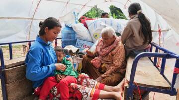 A Cambodian family returns home from a temporary shelter following a Thai-Cambodian ceasefire deal. Photo: AP PHOTO