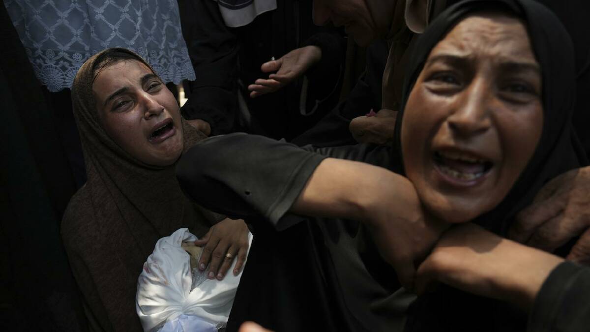 A woman mourns as she holds the body of her 11-year-old son, who was killed in an Israeli airstrike. (AP PHOTO)