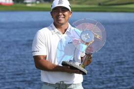 Kurt Kitayama celebrates with the trophy after winning the 3M Open in Minnesota. Photo: AP PHOTO