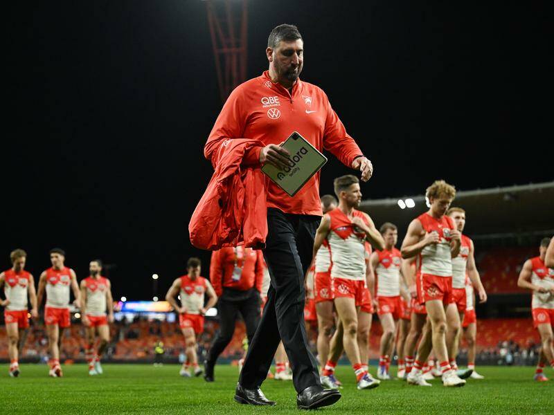 A dejected Swans head coach Dean Cox leads his side off following their loss to the Giants. Photo: Dean Lewins/AAP PHOTOS
