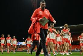 A dejected Swans head coach Dean Cox leads his side off following their loss to the Giants. Photo: Dean Lewins/AAP PHOTOS