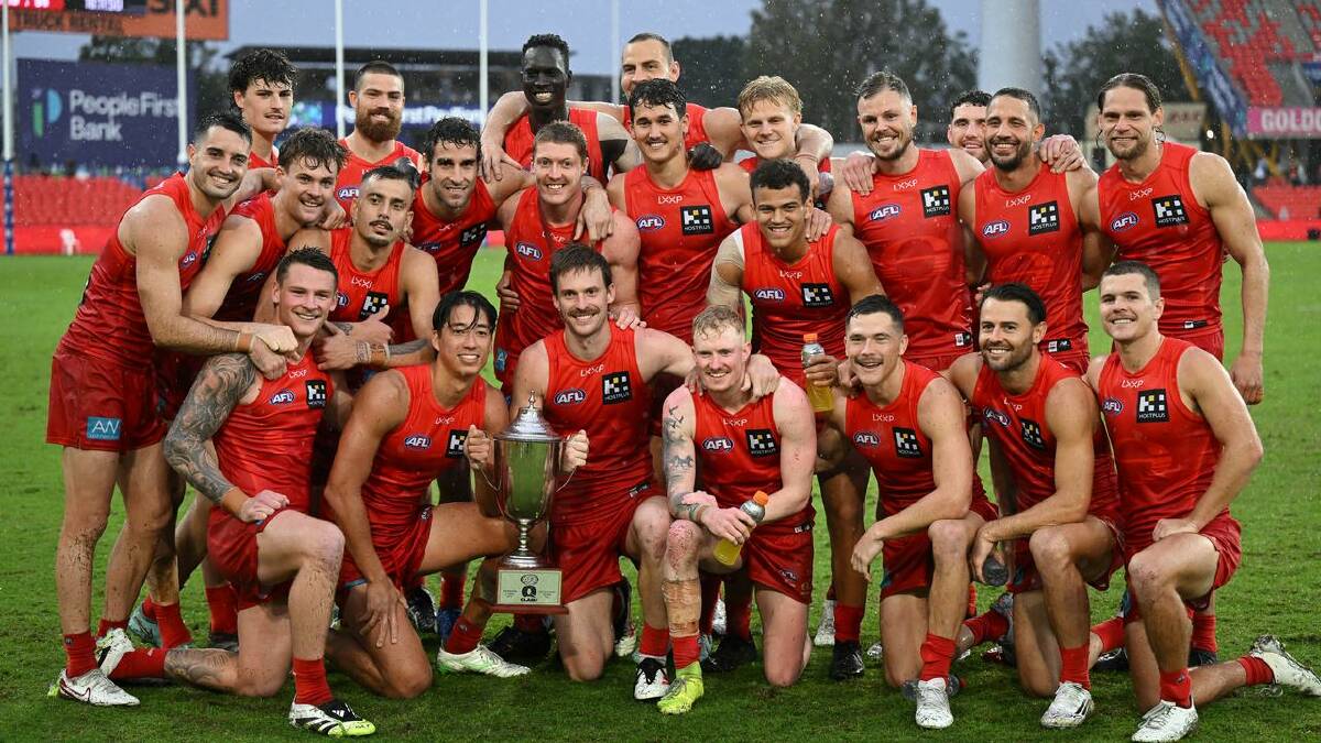 The Suns players took a firm grip on the Q Cup after their record win over the Lions. (Dave Hunt/AAP PHOTOS) The Suns players took a firm grip on the Q Cup after their record win over the Lions. (Dave Hunt/AAP PHOTOS)