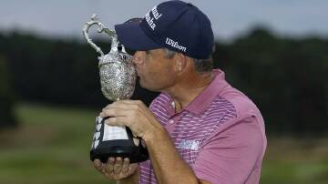 Padraig Harrington celebrates with the trophy after winning the Senior British Open at Sunningdale. Photo: AP PHOTO