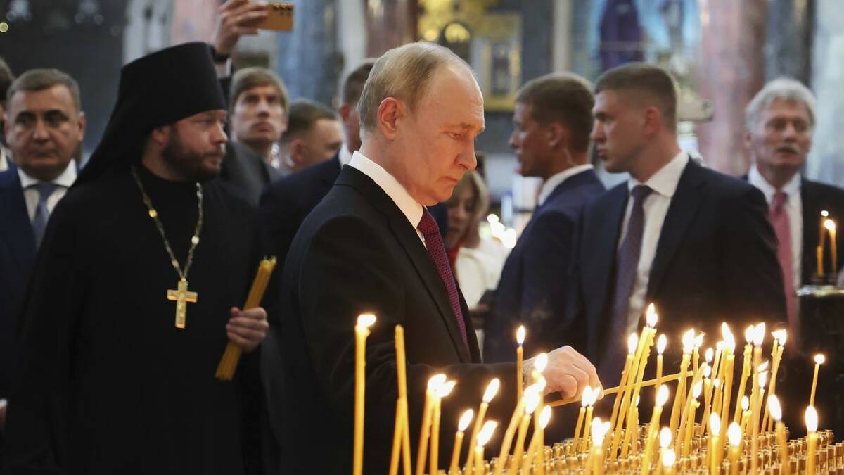 Vladimir Putin lights a candle at the Naval Cathedral of Saint Nicholas near St Petersburg. (AP PHOTO) Vladimir Putin lights a candle at the Naval Cathedral of Saint Nicholas near St Petersburg. (AP PHOTO)