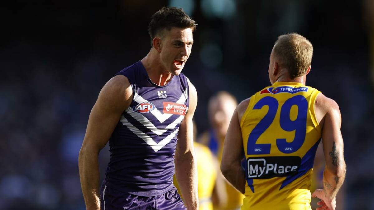 Fremantle's Patrick Voss let the Eagles' Clay Hall know he had just kicked a goal.  (James Worsfold/AAP PHOTOS)