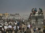 Gaza residents carry bags of flour after lorries with food aid were allowed into the enclave. Photo: EPA PHOTO