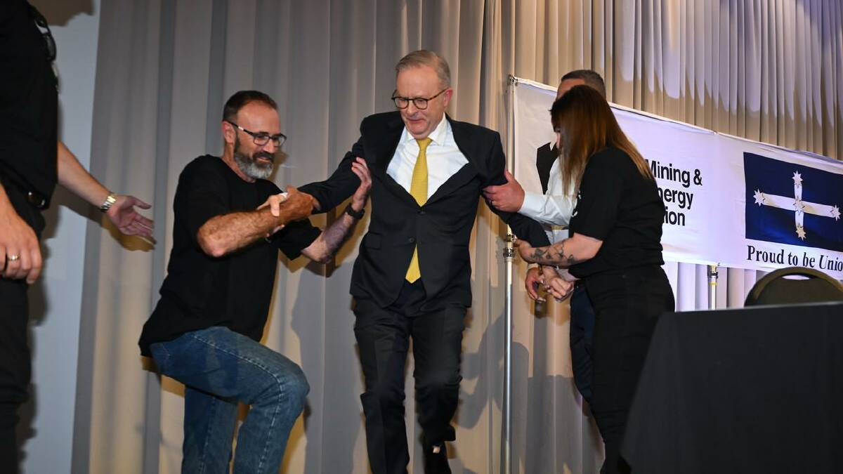 Prime Minister Anthony Albanese was in safe hands after taking a tumble during a photo opportunity. (Lukas Coch/AAP PHOTOS) Prime Minister Anthony Albanese was in safe hands after taking a tumble during a photo opportunity. (Lukas Coch/AAP PHOTOS)