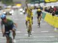 Tadej Pogacar savours the moment of victory as he crosses the finish line of the final stage. Photo: AP PHOTO