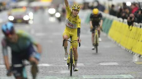Tadej Pogacar savours the moment of victory as he crosses the finish line of the final stage. Photo: AP PHOTO
