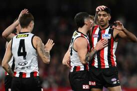 St Kilda teammates congratulate Nasiah Wanganeen-Milera (right) for scoring against the Demons. Photo: Joel Carrett/AAP PHOTOS