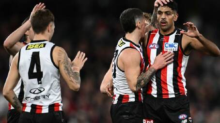 St Kilda teammates congratulate Nasiah Wanganeen-Milera (right) for scoring against the Demons. Photo: Joel Carrett/AAP PHOTOS