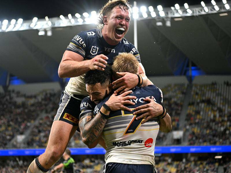 Cowboys teammates congratulate captain Tom Dearden on one of his two tries against the Dragons.  Photo: Scott Davis/AAP PHOTOS