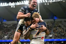 Cowboys teammates congratulate captain Tom Dearden on one of his two tries against the Dragons.  Photo: Scott Davis/AAP PHOTOS