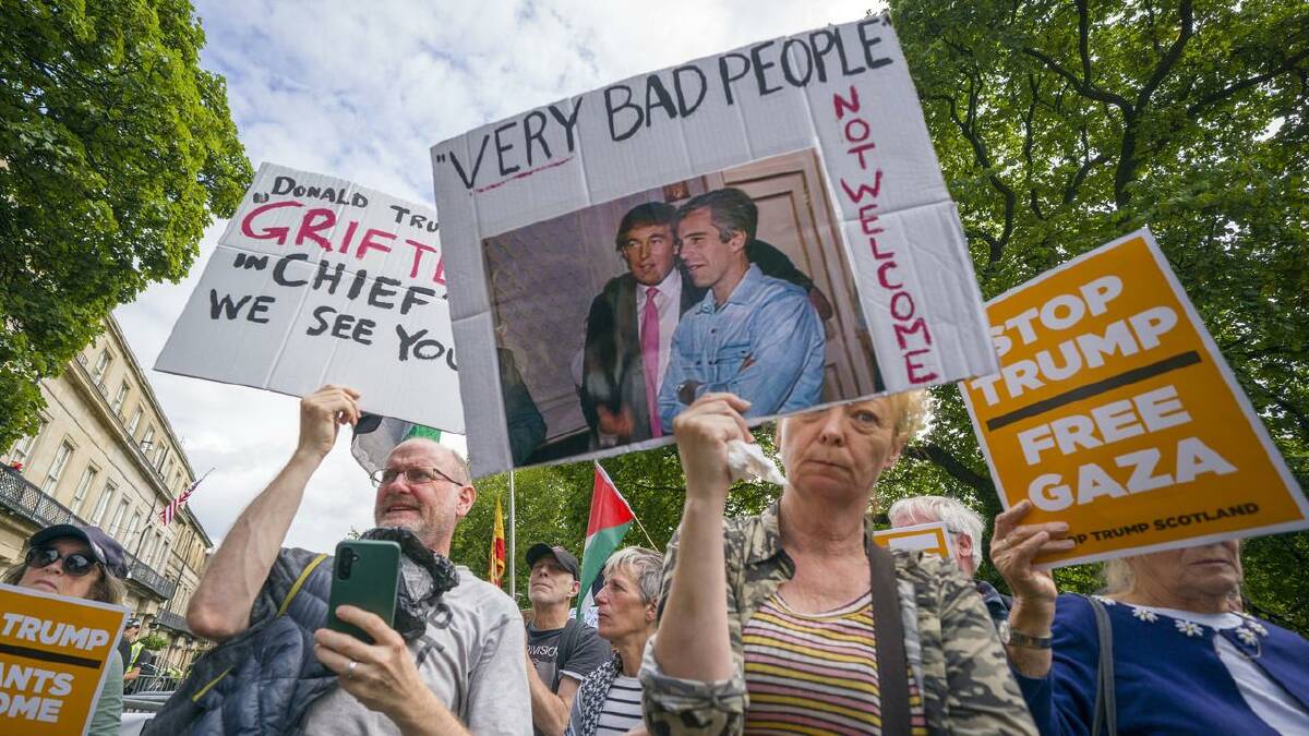 Protesters held placards with photos of Trump and Epstein, while others had pro-Palestinian signs. (AP PHOTO) Protesters held placards with photos of Trump and Epstein, while others had pro-Palestinian signs. (AP PHOTO)