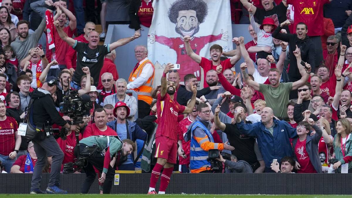 Salah takes a selfie with a fan's phone as he celebrates his goal. (AP PHOTO) Salah takes a selfie with a fan's phone as he celebrates his goal. (AP PHOTO)