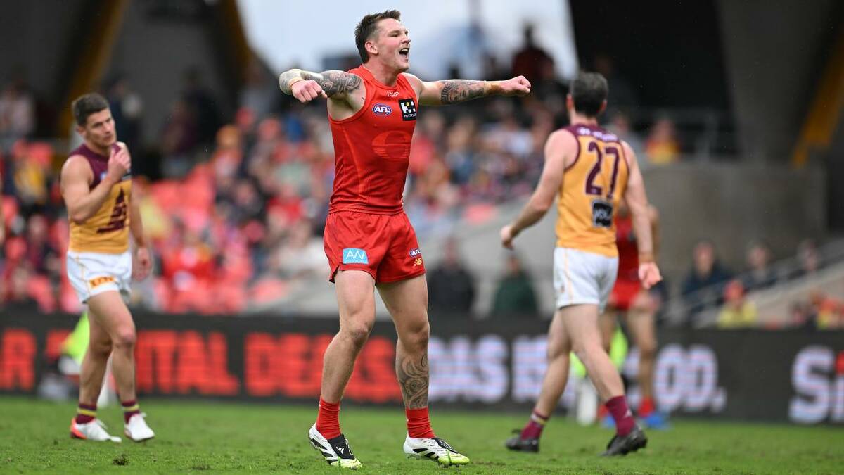 Gold Coast's Bailey Humphrey flexed his muscles with three goals in the crushing win over the Lions. (Dave Hunt/AAP PHOTOS)