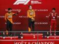 Oscar Piastri  is flanked by McLaren team-mate Lando Norris and Ferrari's Charles Leclerc.  Photo: AP PHOTO
