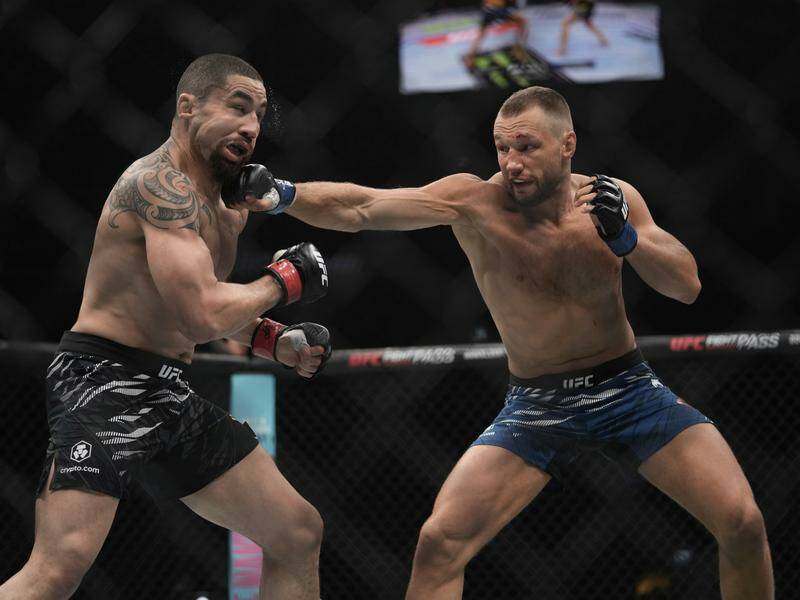 Robert Whittaker and Reinier de Ridder battle it out during their UFC middleweight fight in the UAE. Photo: AP PHOTO Robert Whittaker and Reinier de Ridder battle it out during their UFC middleweight fight in the UAE. Photo: AP PHOTO