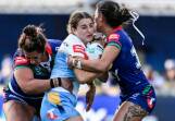 Titans try-scorer Lily Patston found herself surrounded in her side's win over the Warriors. Photo: Andrew Cornaga/AAP PHOTOS