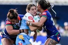 Titans try-scorer Lily Patston found herself surrounded in her side's win over the Warriors. Photo: Andrew Cornaga/AAP PHOTOS