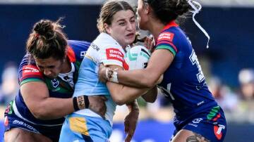 Titans try-scorer Lily Patston found herself surrounded in her side's win over the Warriors. Photo: Andrew Cornaga/AAP PHOTOS