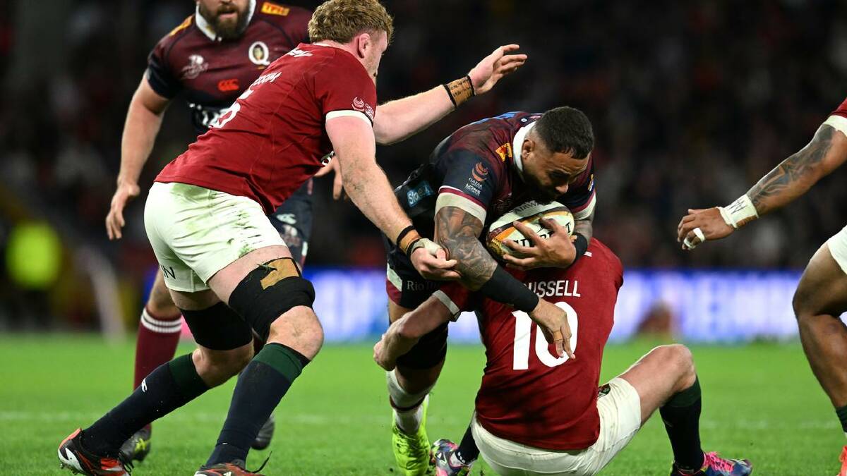 The Lions certainly felt the presence of Lukhan Salakaia-Loto (centre) when they played the Reds.  (Darren England/AAP PHOTOS)