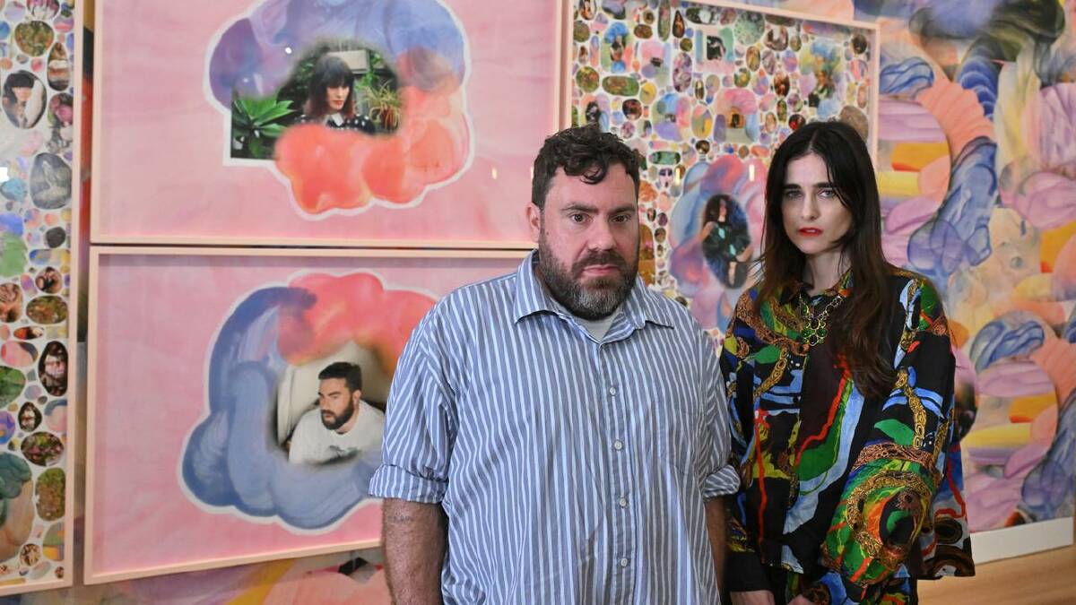 The renowned designers both seem a little overwhelmed by the portrait. (Mick Tsikas/AAP PHOTOS)