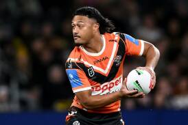 Latu Fainu is only five games into his first stint as a regular starting halfback for the Tigers. Photo: Steven Markham/AAP PHOTOS