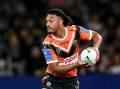 Latu Fainu is only five games into his first stint as a regular starting halfback for the Tigers. Photo: Steven Markham/AAP PHOTOS