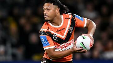 Latu Fainu is only five games into his first stint as a regular starting halfback for the Tigers. Photo: Steven Markham/AAP PHOTOS