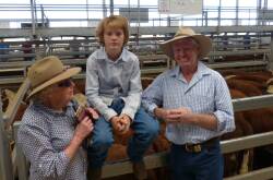 Tony Reardon, Brooklyn Pastoral Company, Mansfield, with son Tom, and mother Margo, with their top pen of Hereford steers at Barnawartha, Wednesday. These steers, 358kgs, sold for $1145.
