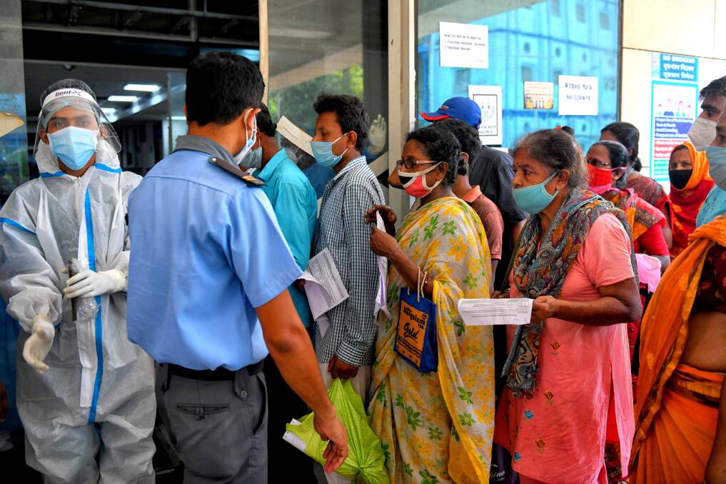 People with COVID-19 symptoms queue for an Antigen Test at a government hospital in Kolkata. Picture: Getty Images
People with COVID-19 symptoms queue for an Antigen Test at a government hospital in Kolkata. Picture: Getty Images